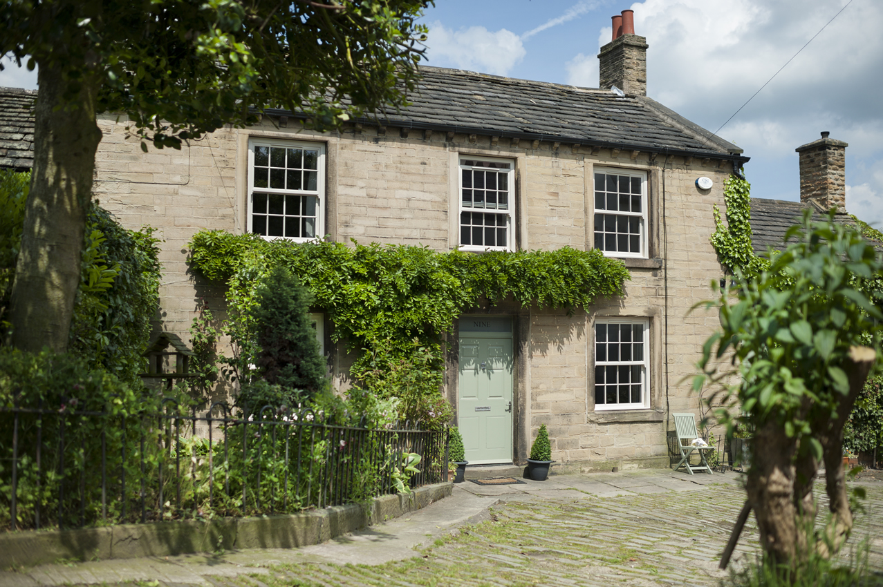 photo of rustic farm house property with white sliding sash windows and pastel mint green composite door - Glaze Windows And Doors